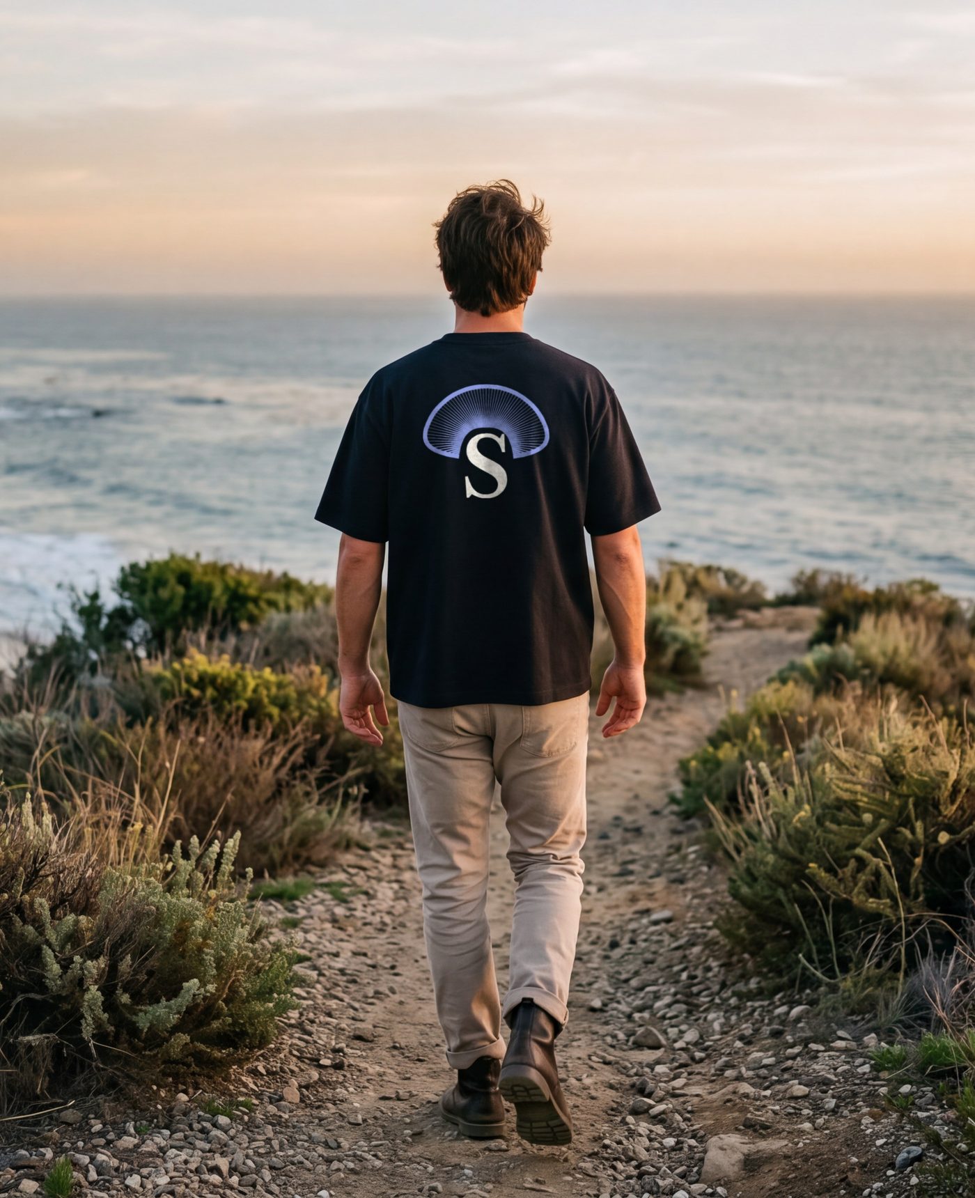 The near-black tee worn on the coast path above the beach in Malibu.
